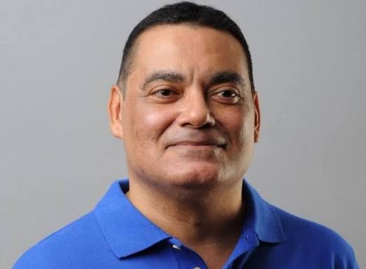 Informal portrait of Francis Fonseca in a blue polo shirt against a plain grey background.