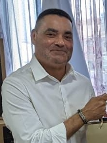 Portrait of Francis Fonseca in a white shirt beside a window, photographed in 2022.